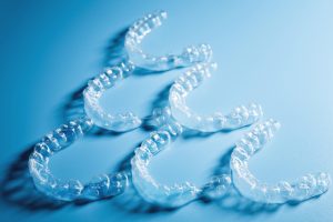 Invisalign clear aligners on the blue background