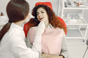Woman in the dentist's office. Doctor in a uniform.