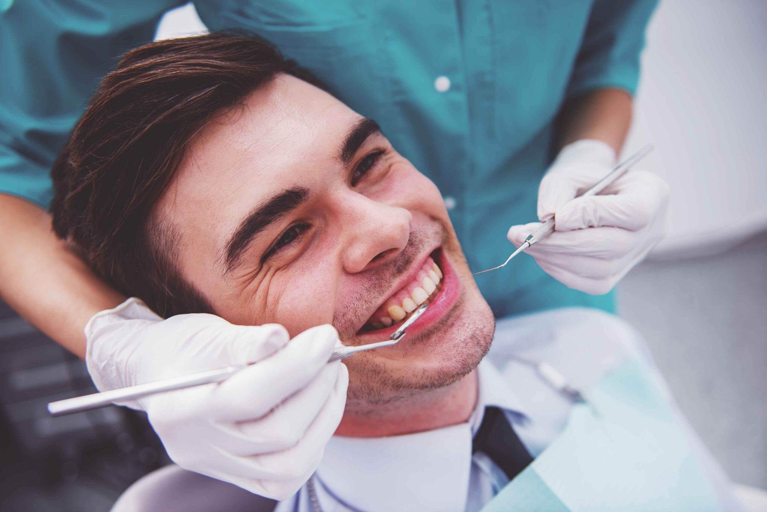 Patient smiling during a dental examination.