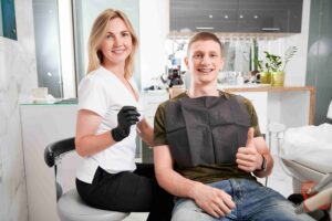 Dental professional and patient smiling after a dental visit.