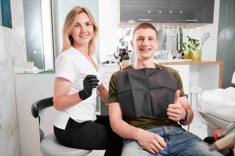 Dental professional and patient smiling after a dental visit.