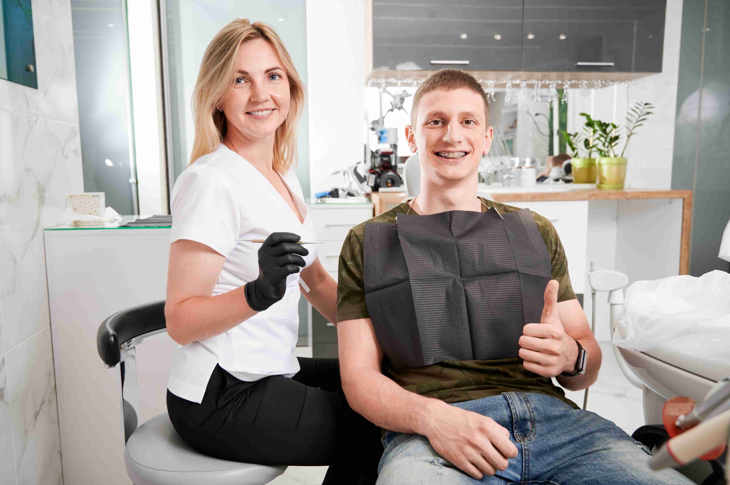 Dental professional and patient smiling after a dental visit.