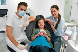 Child smiling in a dental chair.