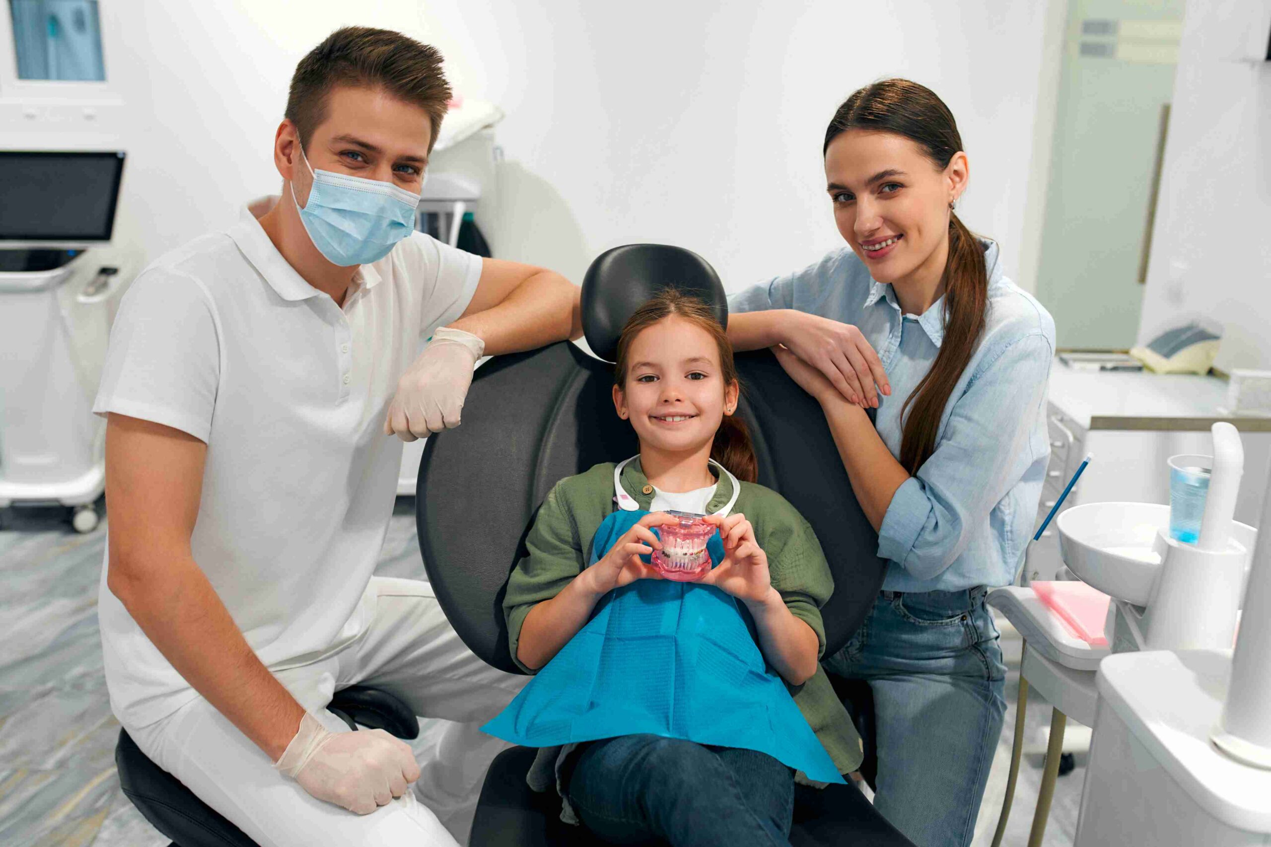 Child smiling in a dental chair.