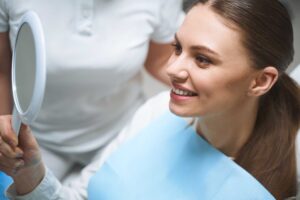 Patient smiling while looking in a mirror.