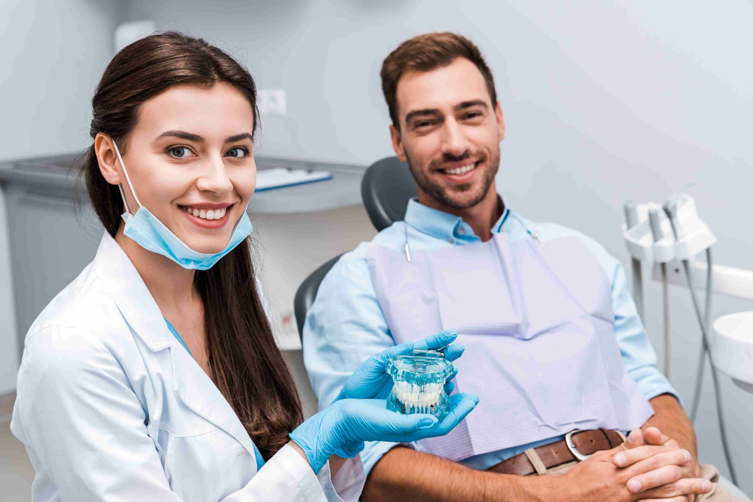 Dentist showing a dental model to a patient.